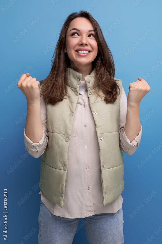 joyful successful brunette young woman in casual look looks up joyful successful brunette young woman in casual look looks up