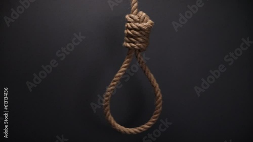 Rope noose with hangman knot on dark background, death penalty concept