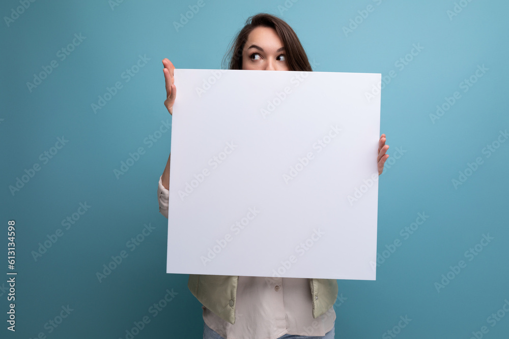 young brunette woman showing information on white screen young brunette woman showing information on white screen