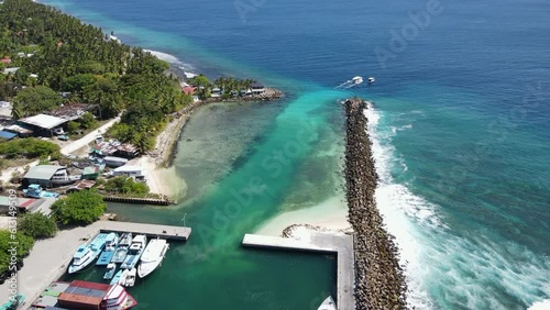 Aerial view of boat jetty at Fuvahmulah Harbour, fishing port and famous dive site for tiger sharks, Fuvahmulah Island, Gnaviyani Atoll or Nyaviyani Atoll, Maldives. 4K footage drone video