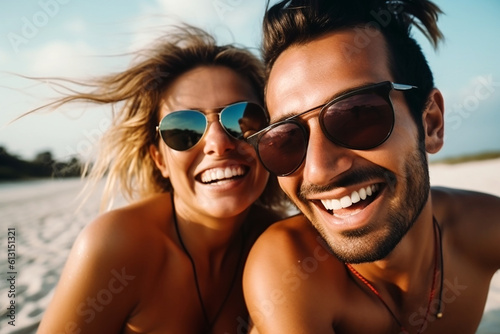 young couple with sunglasses has fun iat beach during hot summer. Vacation and holiday picture for wallpaper or background.  photo