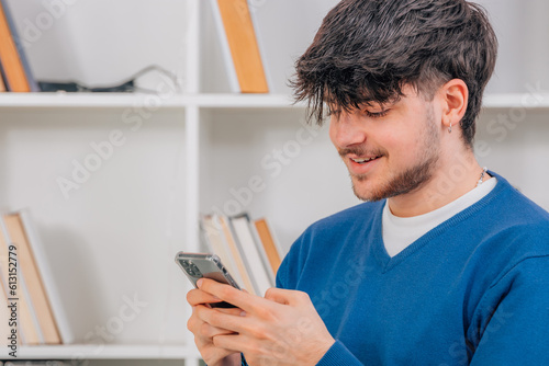 young male student with mobile phone or smartphone