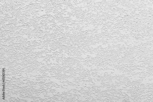 White-gray uniform background of decorative multilayer plaster on the wall, grunge background.