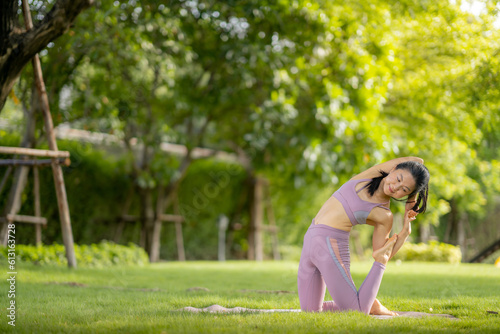 Asian woman wearing yoga clothes doing yoga at her village garden in the morning, happily, Sports healthy lifestyle concepts, Japanese concepts.