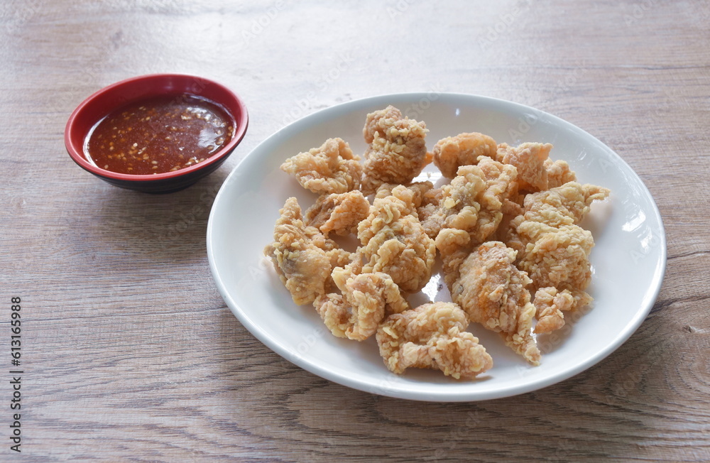 crispy fried Korean chicken with bread crumb and egg yolk on plate dipping barbecue sauce crispy fried Korean chicken with bread crumb and egg yolk on plate dipping barbecue sauce