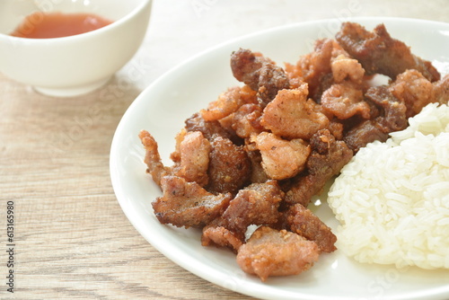 fried salty pork eat with sticky rice on dish dipping spicy chili sauce