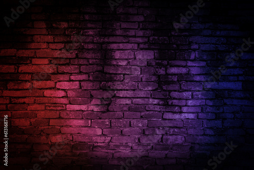 Neon light on brick walls that are not plastered background and texture. Lighting effect red and blue neon background of empty brick basement wall.