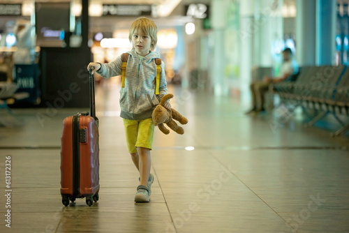Children, brothers, traveling for summer holiday, waiting at the airport to board the aircraft