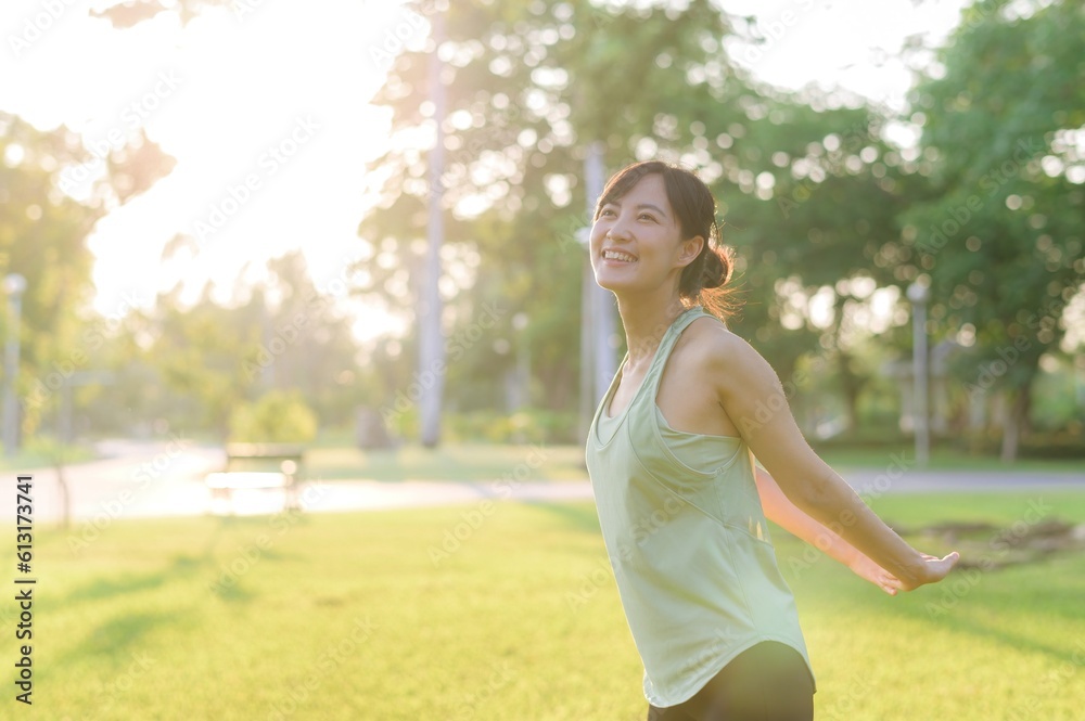 Female jogger. Fit young Asian woman with green sportswear stretching muscle in park before running and enjoying a healthy outdoor. Fitness runner girl in public park. Wellness being concept Female jogger. Fit young Asian woman with green sportswear stretching muscle in park before running and enjoying a healthy outdoor. Fitness runner girl in public park. Wellness being concept