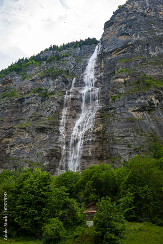 Mürrenbachfall or Murrenbach falls famous waterfall in the Swiss Alps. Wide, low-angle shot, sunny summer day, no people