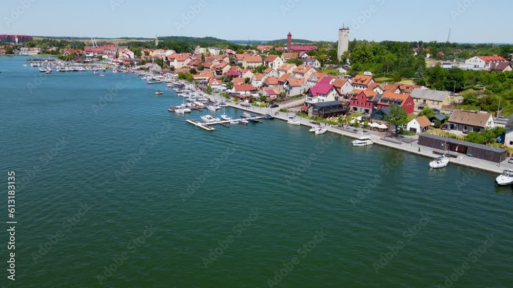 Beautiful panoramic aerial 4K video from drone to Mikolajki townscape - capital of Masurian region on the shore of the holiday resort beautiful summer afternoon. Mikolajki ,Mikołajki, Poland, Europe. Beautiful panoramic aerial 4K video from drone to Mikolajki townscape - capital of Masurian region on the shore of the holiday resort beautiful summer afternoon. Mikolajki ,Mikołajki, Poland, Europe.
