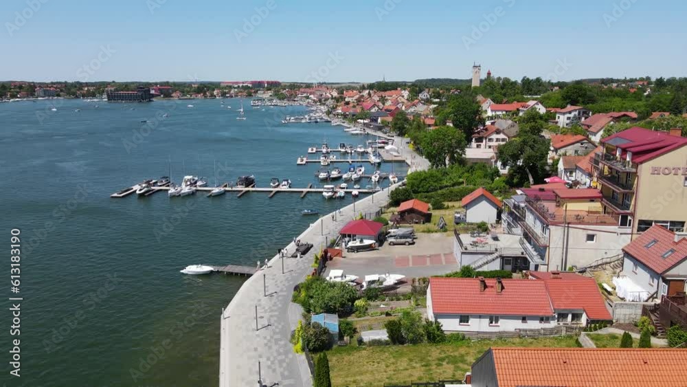 Beautiful panoramic aerial 4K video from drone to Mikolajki townscape - capital of Masurian region on the shore of the holiday resort beautiful summer afternoon. Mikolajki ,Mikołajki, Poland, Europe. Beautiful panoramic aerial 4K video from drone to Mikolajki townscape - capital of Masurian region on the shore of the holiday resort beautiful summer afternoon. Mikolajki ,Mikołajki, Poland, Europe.