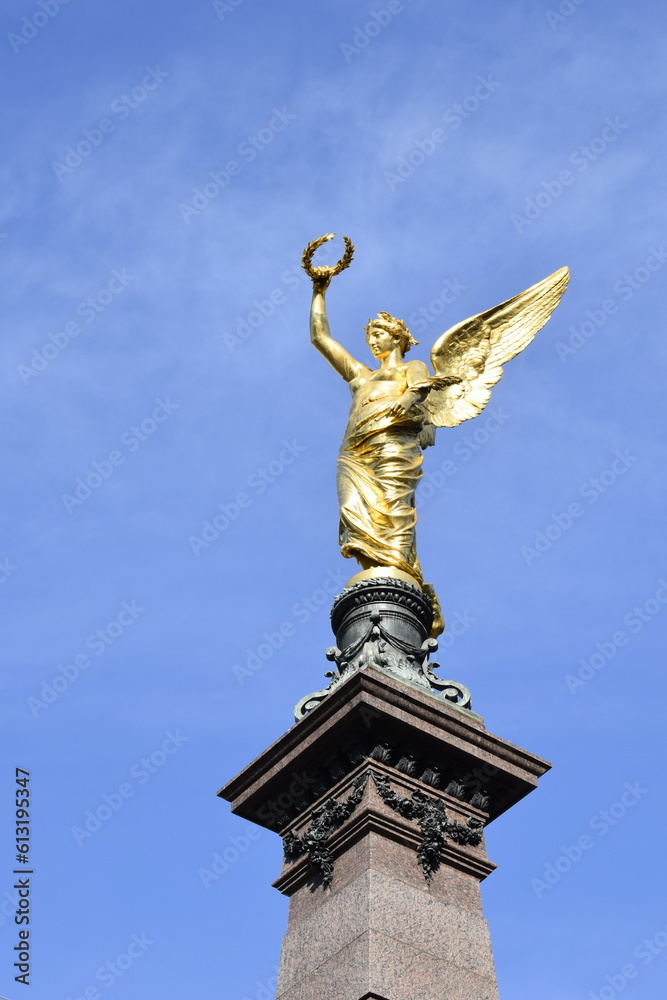 Fototapeta premium Golden angel statue on the monument for Johann Andreas von Liebenberg, Mayor of Vienna during the Second Siege of Vienna by the Turks in 1683. Monument inaugurated in 1890. It is in Vienna, Austria.