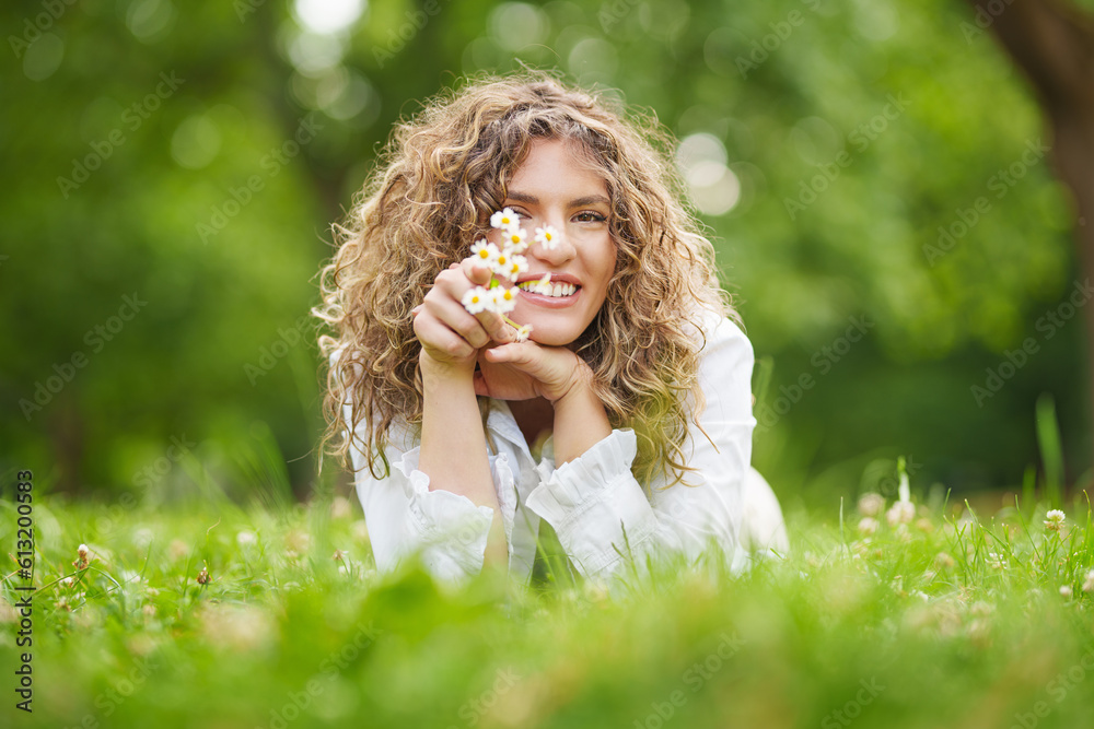 smiling beautiful young girl with curly hair in camomile field smiling beautiful young girl with curly hair in camomile field