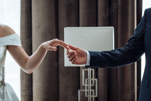bride and groom touch fingers