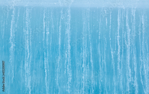 Texture of winter ice surface. Blue natural ice background