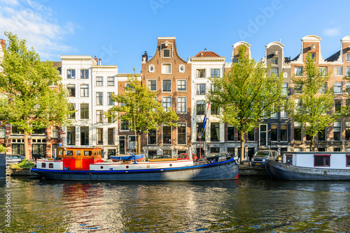 Photography Traditional dutch architecture along a canal in Amsterdam at sunset in summer