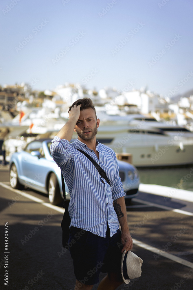 Obraz premium A man in a yacht marina in Marbella, Spain.