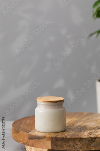 White interior candle in a glass jar. Home decor, comfort. Handmade candle