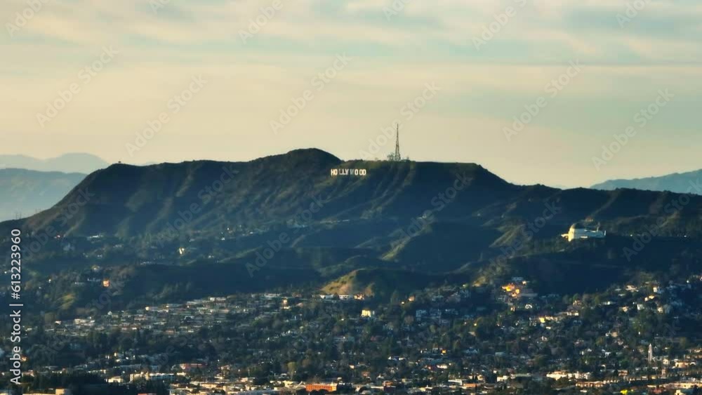 Zoomed footage of hills above city. Radio transmitter and famous Hollywood sign. Los Angeles, California, USA