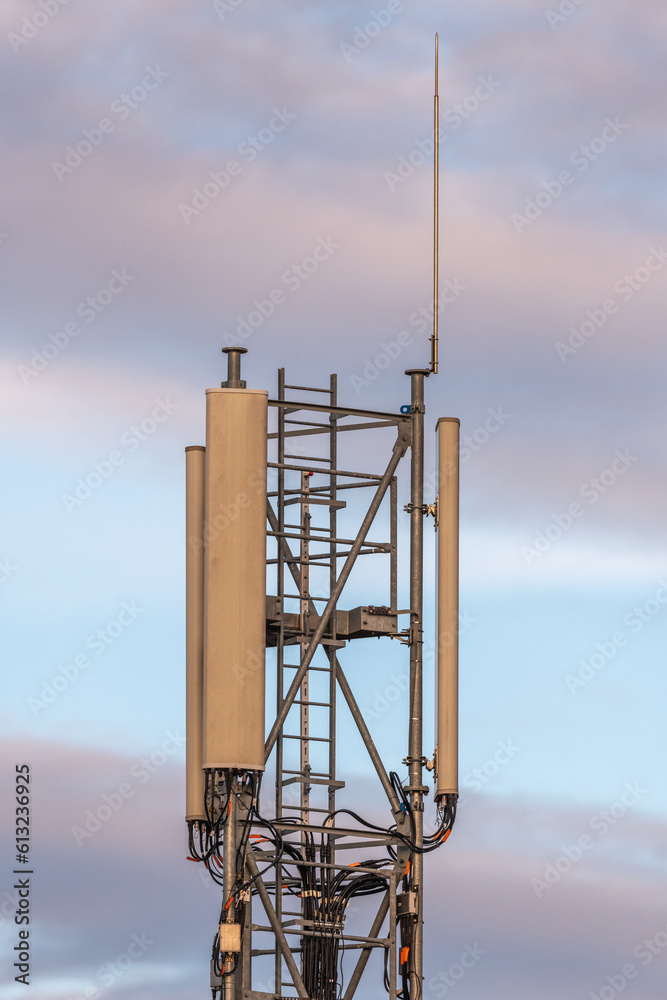 Telecommunication antenna close-up at dusk.