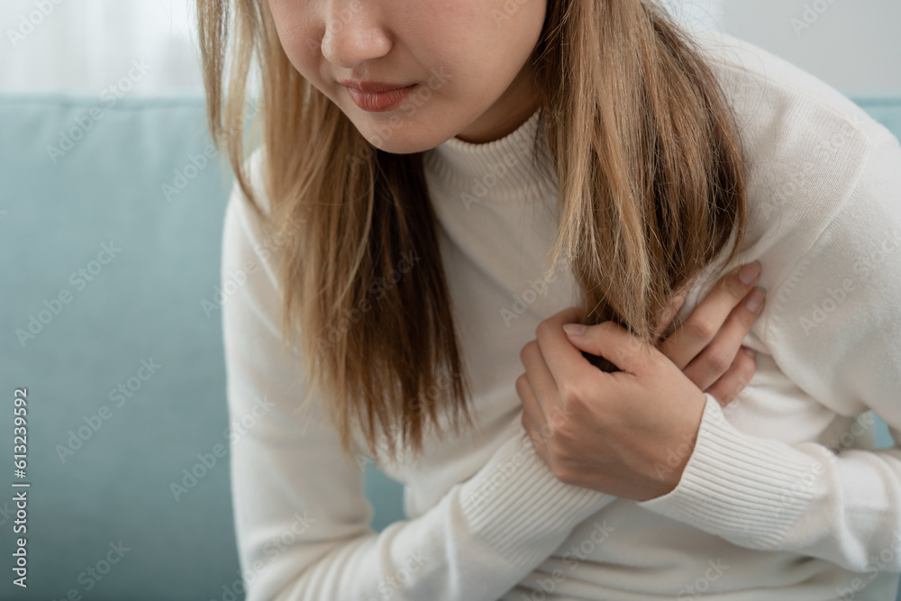 hand hold chest with heart attack symptoms, asian woman have chest pain
