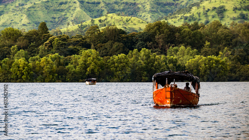 Orange Boat Sailing on the Serene Koyna Lake in Maharashtra