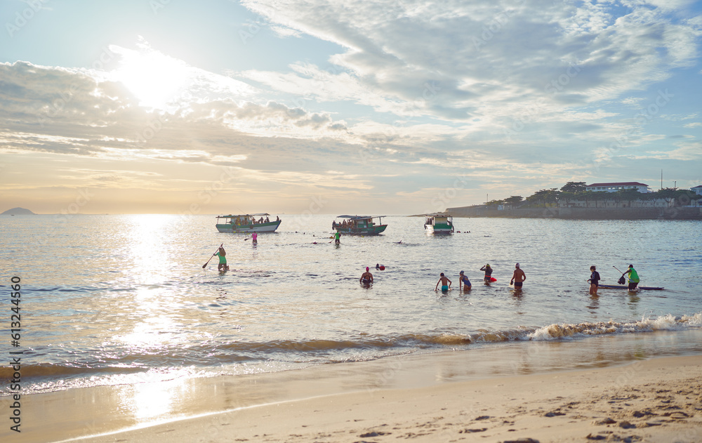 group of sporty people entering the water to swim train at sunrise in Copacabana Rio de Janeiro group of sporty people entering the water to swim train at sunrise in Copacabana Rio de Janeiro