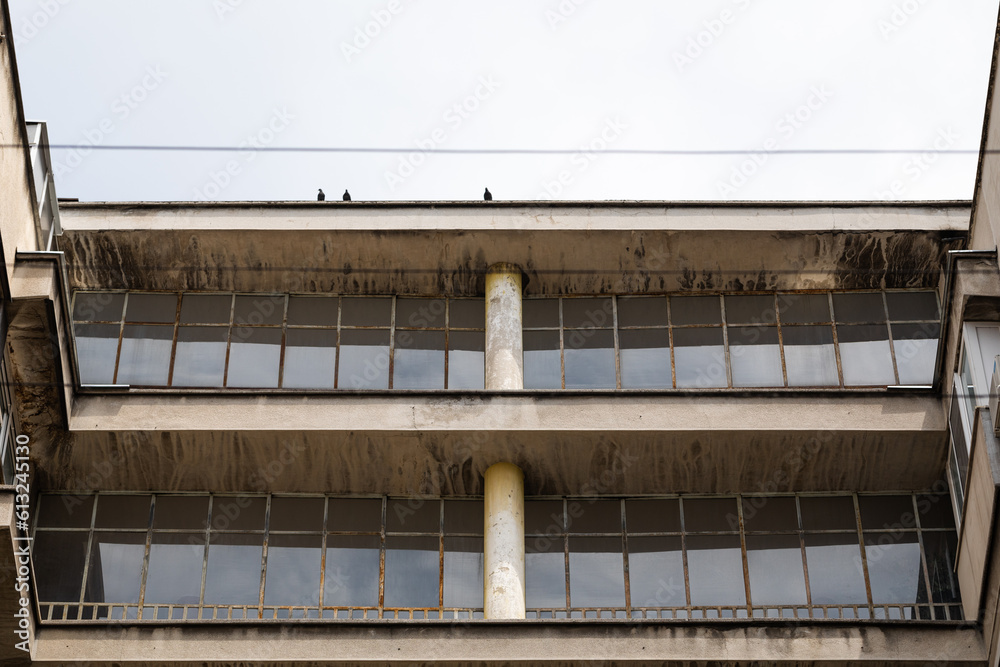 Fragment of the facade of a constructivist building. Tape glazing and a column in the middle. Fragment of the facade of a constructivist building. Tape glazing and a column in the middle.
