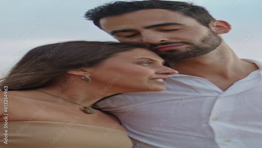 Lovely family cuddling at misty ocean closeup. Happy pair walking beach vertical Lovely family cuddling at misty ocean closeup. Happy pair walking beach vertical