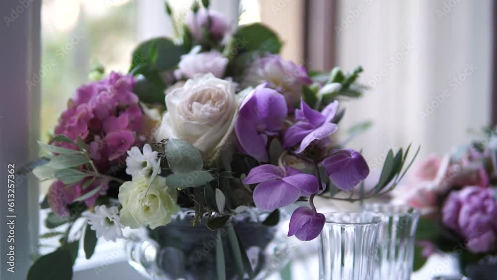 A fresh, purple floral arrangement in an indoor setting. A fresh, purple floral arrangement in an indoor setting.