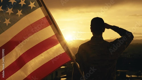 American soldier salutes sunset light