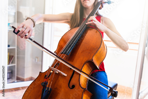 Concert Preparation: Young Cellist Devotedly Rehearsing at Home