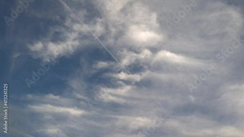 Clouds that look like cirrostratus move across the sky in the afternoon
