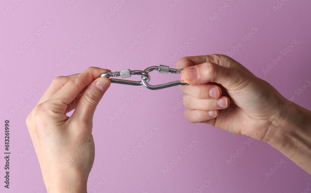 Fototapeta premium Metal carbines in a female hands on a purple background