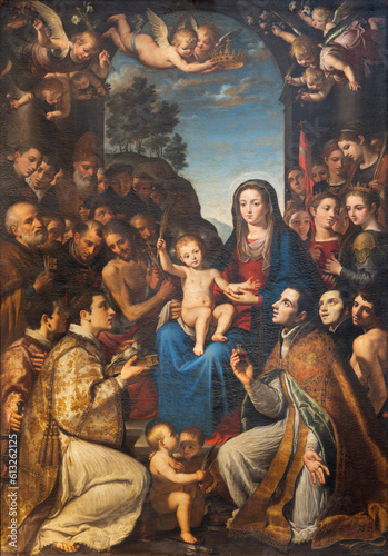 NAPLES, ITALY - APRIL 19, 2023: The painting of Madonna among the saints in the church Chiesa del Gesu Nuovo by Giovanni Bernardino Azzolino (1614).