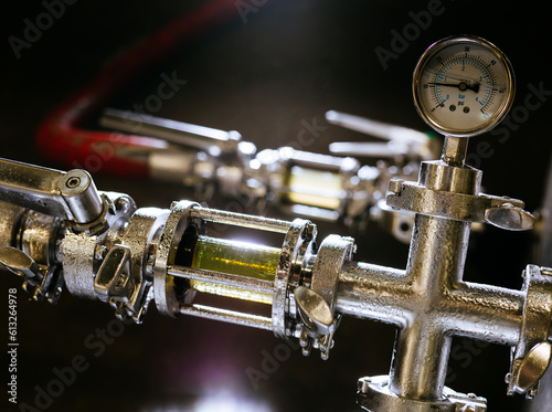 Stainless steel pipes carry unfiltered (far) and filtered (close) beer at a brewery