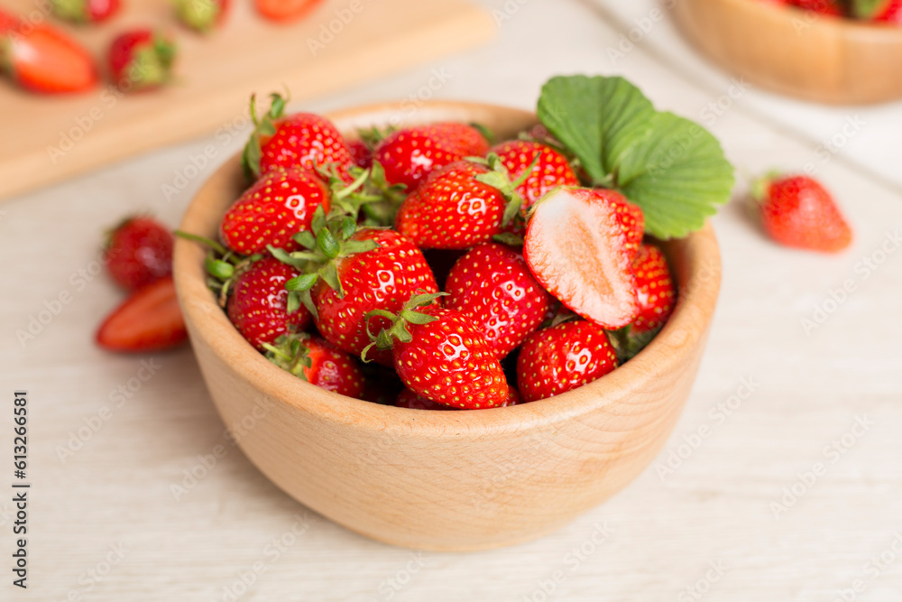 Fresh strawberries in bowl on wooden table Fresh strawberries in bowl on wooden table