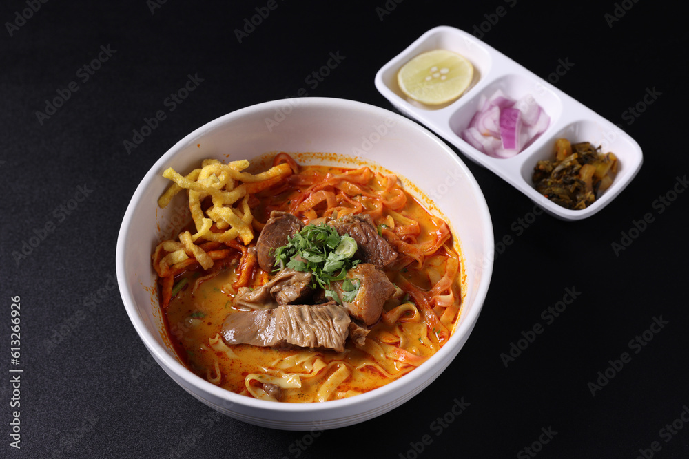 Khao Soi Thai Curry soup isolated in black background Khao Soi Thai Curry soup isolated in black background