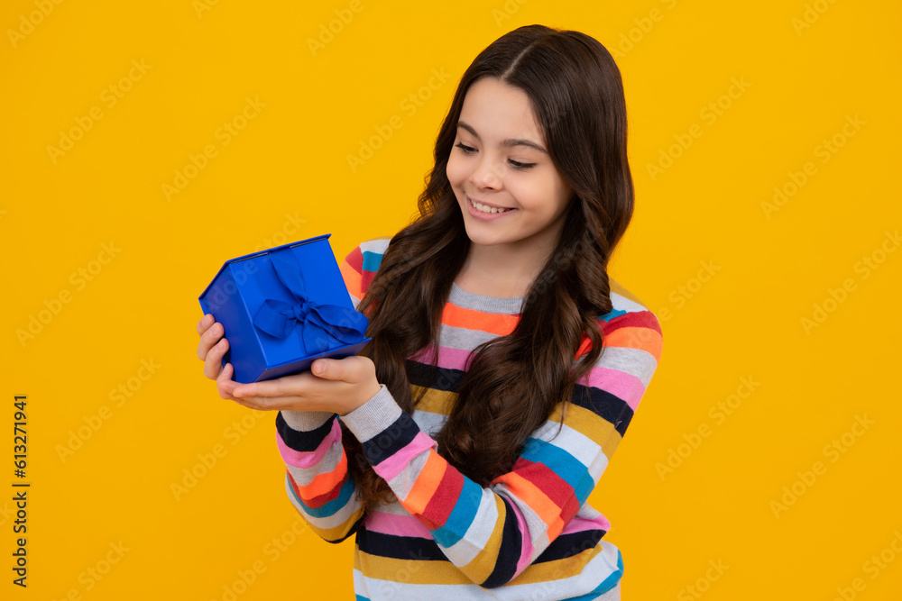 Teenager child with gift box. Present for holidays. Happy birthday, Valentines day, New Year or Christmas. Kid hold present box. Happy teenage girl, positive and smiling emotions. Teenager child with gift box. Present for holidays. Happy birthday, Valentines day, New Year or Christmas. Kid hold present box. Happy teenage girl, positive and smiling emotions.
