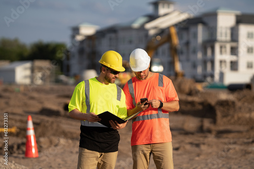 architect men with construction project. architect men with construction project. architect men discussing construction project outdoor. architect men have construction project on clipboard
