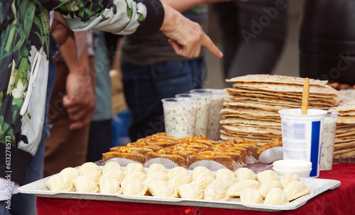 Photography A visitor to the street market choosing a snack from a stand selling Azerbaijani