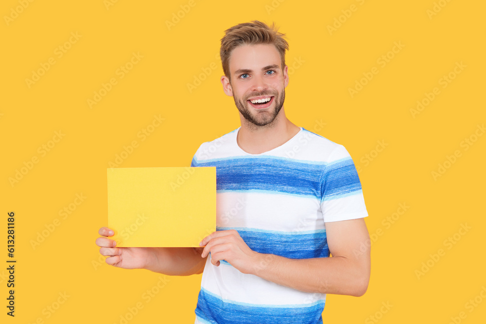 man smile offer product advertisement. man holds paper with special offer advertisement. man show advertisement and offer promotion isolated on yellow. man sales representative offer advertisement man smile offer product advertisement. man holds paper with special offer advertisement. man show advertisement and offer promotion isolated on yellow. man sales representative offer advertisement