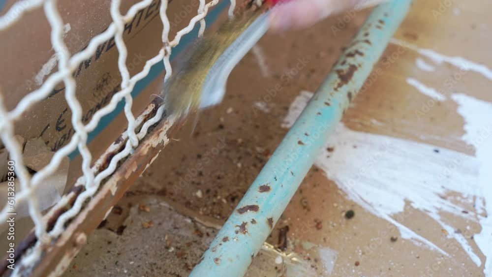 Video Stock Rubbing metal surface with faded paint and rust using