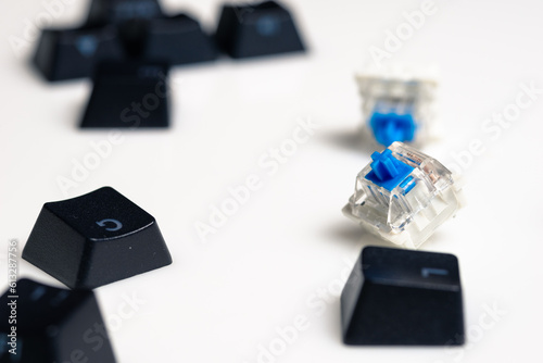 Keycaps and Keyswitch for Mechanical Keyboards Scattered on White Background