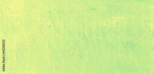 Yellow speckled hand-painted illustration texture design of old distressed vintage grunge concrete with green stains. damaged textured abstract washed cement backdrop as web banner background.