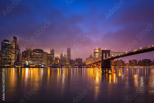 Panoramic view on Manhattan and Brooklyn bridge at night, New York City © sborisov