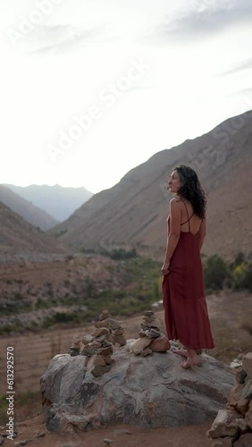 latin american woman standing on the rock and looking in the valley of Cochiguaz photo