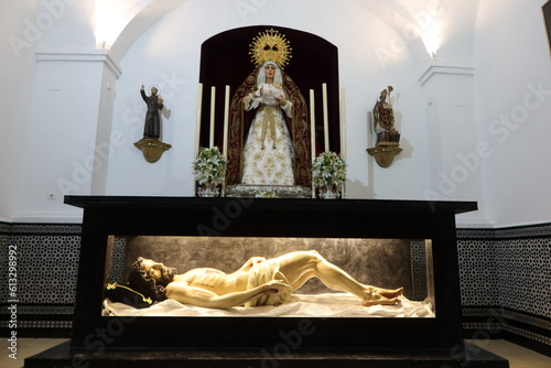 Aracena, Huelva, Spain, June 12, 2023: Virgin Mary and the prostrate body of Jesus Christ in the Church of Nuestra Señora del Carmen. Building of the 16th, 17th century. Aracena, Huelva, Spain photo