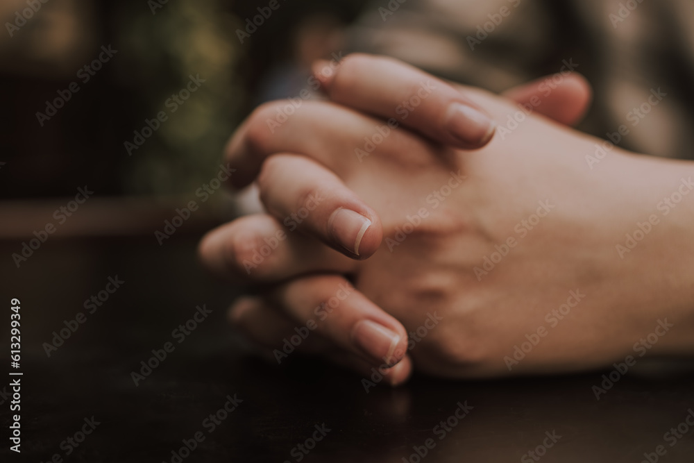 Girl's folded hands on a table in a cafe Girl's folded hands on a table in a cafe